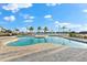 Resort-style pool with a spacious deck, comfortable lounge chairs and palm trees at 1805 7Th St E, Palmetto, FL 34221