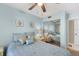 Light blue bedroom featuring a queen bed, ceiling fan, and mirrored closet at 1807 Sunny Dr # E4, Bradenton, FL 34207