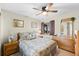 Relaxing bedroom with a ceiling fan, wooden furniture, and neutral decor at 1807 Sunny Dr # E4, Bradenton, FL 34207