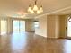 Open living space with tiled floors, sliding glass doors, and elegant light fixture at 20080 Ragazza Cir # 102, Venice, FL 34293