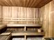 Interior view of a wooden sauna with benches and a traditional bucket for steam at 20080 Ragazza Cir # 102, Venice, FL 34293