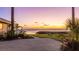 Scenic twilight view of a backyard leading to the water, featuring lush landscaping and a tranquil atmosphere at 202 Gaines Ave, Sarasota, FL 34243