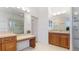 Bright bathroom featuring dual vanities, a large mirror, and a glass-enclosed shower at 202 Gaines Ave, Sarasota, FL 34243