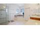 Spa-like bathroom with a whirlpool tub, glass-enclosed shower, and double vanity at 202 Gaines Ave, Sarasota, FL 34243