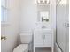 Clean bathroom featuring a white sink, toilet, mirror, and enclosed shower with sliding glass door at 202 Gaines Ave, Sarasota, FL 34243