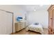 Cozy bedroom featuring wood floors, a ceiling fan, a TV, and a window for natural light at 202 Gaines Ave, Sarasota, FL 34243