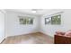 Inviting bedroom with wood floors, bright windows, and comfortable lounging space at 202 Gaines Ave, Sarasota, FL 34243
