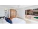 Bright bedroom features a wardrobe, and sliding glass doors with a view of the pool at 202 Gaines Ave, Sarasota, FL 34243