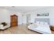 Bedroom with a large antique cabinet, cozy chair, and bright natural light at 202 Gaines Ave, Sarasota, FL 34243