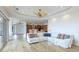 Bright living room showing the kitchen, fireplace, and sliding doors to the pool at 202 Gaines Ave, Sarasota, FL 34243