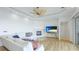 Bright, open-concept living room with a fireplace, modern ceiling fan, and neutral decor at 202 Gaines Ave, Sarasota, FL 34243