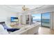 Bright living room featuring a fireplace, TV, and sliding glass doors leading to the pool and water views at 202 Gaines Ave, Sarasota, FL 34243