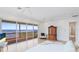 Bright main bedroom featuring water views, balcony access and an antique cabinet at 202 Gaines Ave, Sarasota, FL 34243