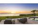Gorgeous outdoor patio with comfortable seating overlooking the serene water and sunset at 202 Gaines Ave, Sarasota, FL 34243