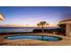 Backyard pool overlooks a sunset ocean view at twilight in this scenic yard at 202 Gaines Ave, Sarasota, FL 34243
