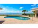 Backyard pool overlooks a scenic view of the ocean on a clear and sunny day at 202 Gaines Ave, Sarasota, FL 34243