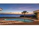 Backyard pool overlooks a sunset ocean view at twilight in this scenic yard at 202 Gaines Ave, Sarasota, FL 34243