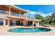 Stunning pool with clear blue water, patio area, and views of the home's architecture and beautiful landscaping at 202 Gaines Ave, Sarasota, FL 34243