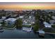 Aerial view of waterfront property with a private pool and dock, nestled in a vibrant coastal community at 212 Haverkos Ct, Holmes Beach, FL 34217