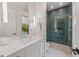 Contemporary bathroom with a walk-in shower, floating vanity, and modern finishes at 212 Haverkos Ct, Holmes Beach, FL 34217