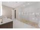 Luxurious bathroom with double sinks, a spacious walk-in shower, and neutral decor at 212 Haverkos Ct, Holmes Beach, FL 34217