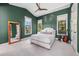 Green bedroom with ample natural light, a vaulted ceiling, and a walk-in closet at 212 Haverkos Ct, Holmes Beach, FL 34217