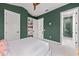 Green bedroom featuring a walk-in closet and an ensuite bathroom with glass shower at 212 Haverkos Ct, Holmes Beach, FL 34217