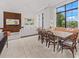 Open-concept dining room adjacent to the living room featuring contemporary decor and tons of natural light at 212 Haverkos Ct, Holmes Beach, FL 34217