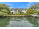 Beautiful waterfront home with lush landscaping and private dock, perfect for boating enthusiasts at 212 Haverkos Ct, Holmes Beach, FL 34217