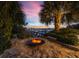 Inviting outdoor fire pit area with seating, perfect for relaxing evenings by the water at 212 Haverkos Ct, Holmes Beach, FL 34217