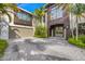 Elegant home showcasing well-maintained landscaping, a large front entrance, and a convenient garage at 212 Haverkos Ct, Holmes Beach, FL 34217