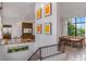 Bright interior with living room, dining area, and staircase with artwork at 212 Haverkos Ct, Holmes Beach, FL 34217