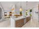 Open kitchen with large island, modern cabinets, and views of the living areas at 212 Haverkos Ct, Holmes Beach, FL 34217
