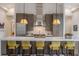 Contemporary kitchen features stainless steel appliances and stylish pendant lighting over the bar at 212 Haverkos Ct, Holmes Beach, FL 34217