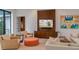 Bright living room with comfortable seating, built-in entertainment center, and stylish decor at 212 Haverkos Ct, Holmes Beach, FL 34217