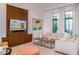 Bright living room featuring comfortable seating, a modern entertainment center, and stylish decor at 212 Haverkos Ct, Holmes Beach, FL 34217
