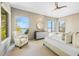 Bright main bedroom with natural light and serene water views from multiple windows at 212 Haverkos Ct, Holmes Beach, FL 34217