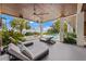 Relaxing outdoor lounge area with pool views, elegant chaise lounges, tropical landscaping, and shade at 212 Haverkos Ct, Holmes Beach, FL 34217