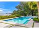 Beautiful pool area with lush landscaping and serene waterfront views at 212 Haverkos Ct, Holmes Beach, FL 34217