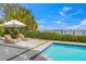 Relaxing lounge area by the pool with waterfront views and a sunny umbrella at 212 Haverkos Ct, Holmes Beach, FL 34217
