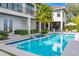 Amazing pool and spa with home exterior featuring an outdoor seating area at 212 Haverkos Ct, Holmes Beach, FL 34217