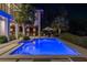 Backyard pool area with outdoor seating, lush landscaping, and ample space for relaxation and entertainment at 212 Haverkos Ct, Holmes Beach, FL 34217