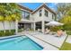 Gorgeous pool and outdoor area with luxury patio seating and lush palms at 212 Haverkos Ct, Holmes Beach, FL 34217