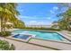 Swimming pool, spa, with views of bay, lounge chairs, and lush landscaping blend for outdoor living space at 212 Haverkos Ct, Holmes Beach, FL 34217