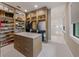 Custom walk-in closet with a center island and storage for shoes, handbags, and clothing at 212 Haverkos Ct, Holmes Beach, FL 34217