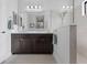 Clean bathroom featuring a double sink vanity, frameless mirror, glass shower, and neutral color palette at 220 Cassano Dr, Nokomis, FL 34275