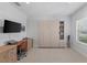 Flex room featuring a murphy bed, built-in shelving, desk space, and neutral tile floors at 220 Cassano Dr, Nokomis, FL 34275