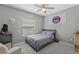 Comfortable bedroom with neutral walls, ceiling fan, and comfortable seating at 220 Cassano Dr, Nokomis, FL 34275