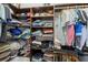 Organized walk-in closet with built-in shelving and ample storage for clothes and accessories at 220 Cassano Dr, Nokomis, FL 34275