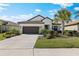 Charming home with manicured lawn and mature landscaping creates inviting curb appeal at 220 Cassano Dr, Nokomis, FL 34275